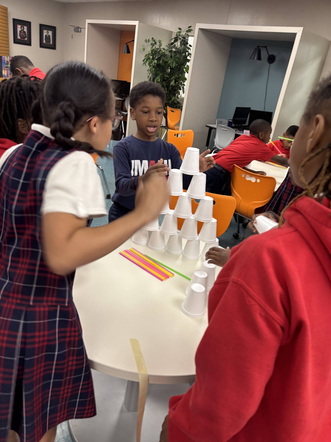 Imani students building a tower during a structural design challenge.